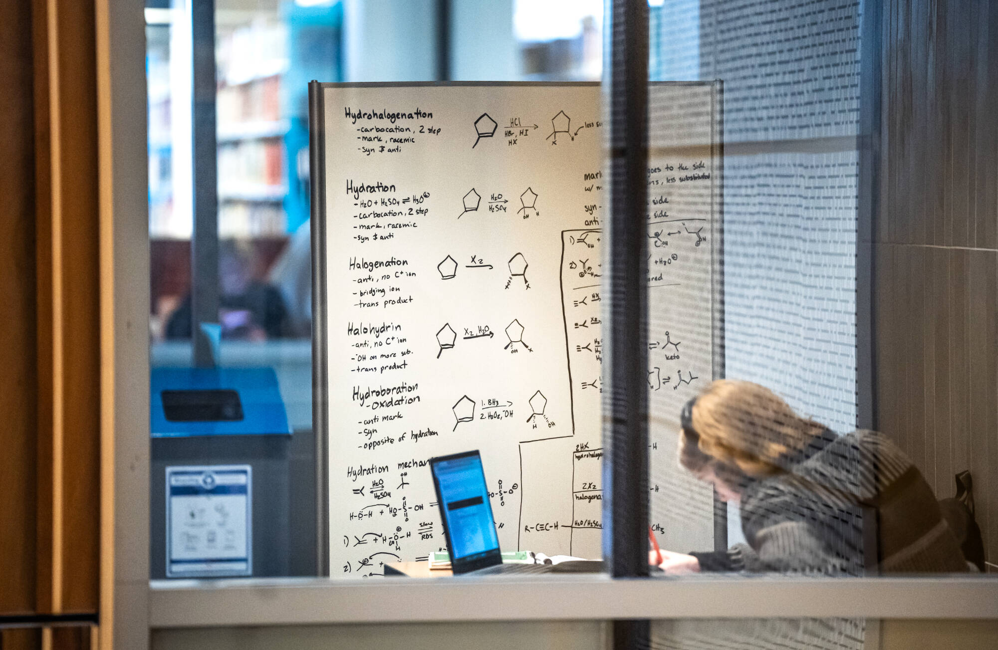 A student is diligently preparing for final exams, utilizing the Mary Idema Pew Library's resources and collaborative spaces to support their academic success on December 4th.